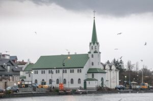 A church sits by the waters edge in Reykjavik, Iceland