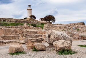 The Roman Odeon within Kato Pafos with the modern lighthouse in the background
