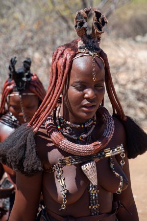 A young Himba girl in traditional dress in her local village