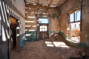 The desert slowly reclaims an empty house in the diamond ghost town of Kolmanskop