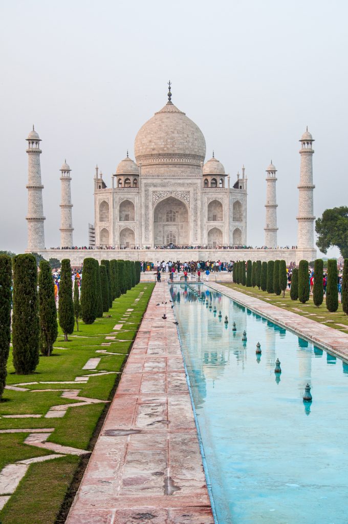 The front view of the Taj Mahal with the fountains in the foreground